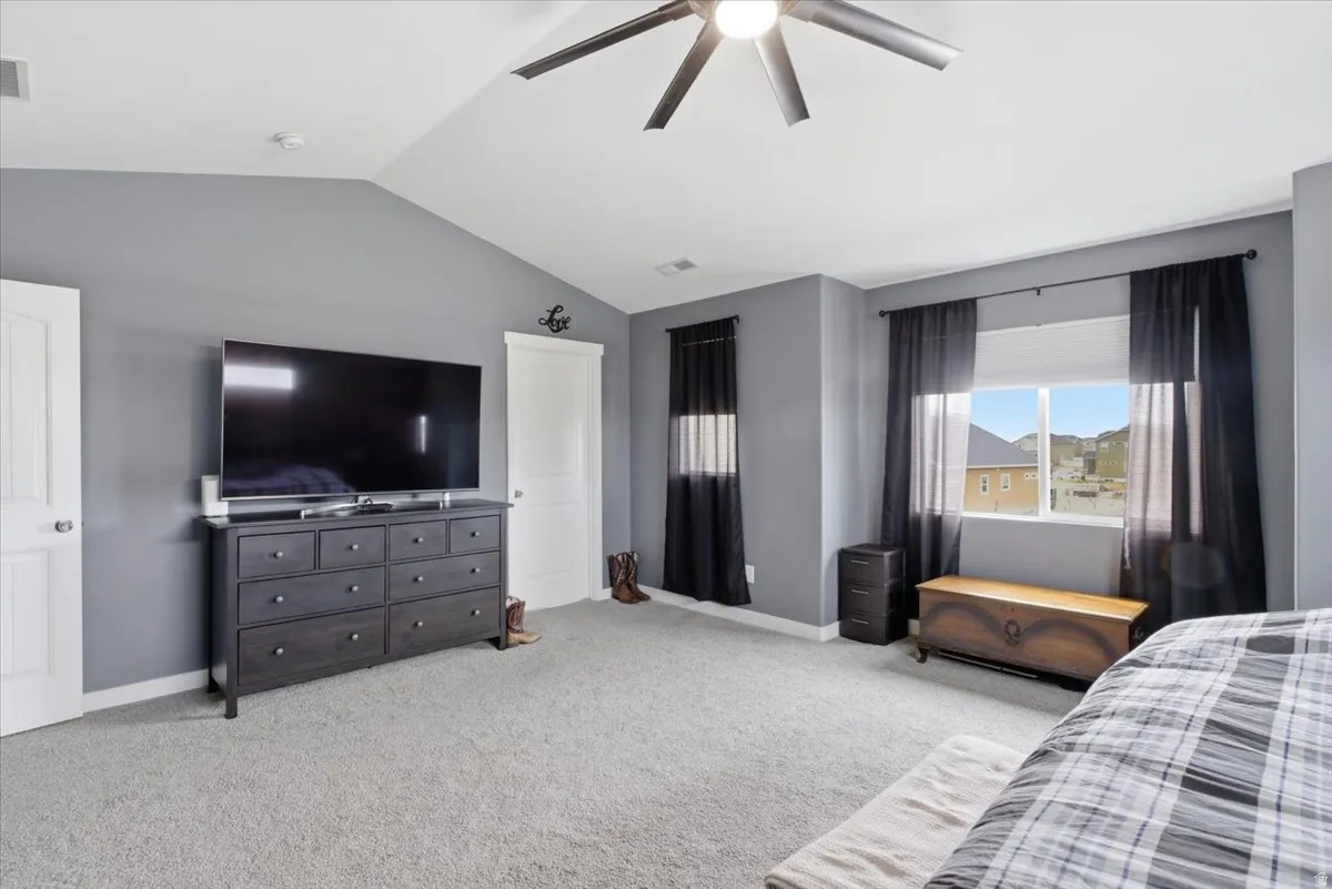 Bedroom featuring light carpet and ceiling fan