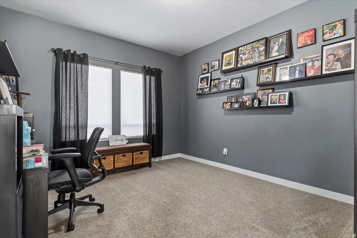 Office space featuring light colored carpet and baseboards
