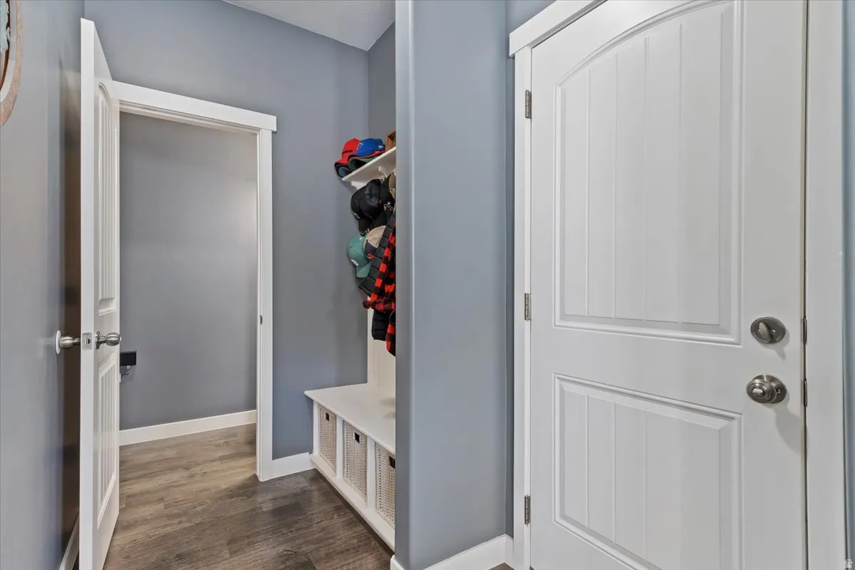 Mudroom with dark wood finished floors and baseboards