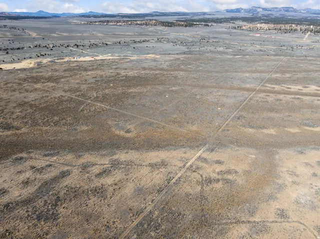 Aerial view of sparsely populated area with a desert landscape and a mountain backdrop