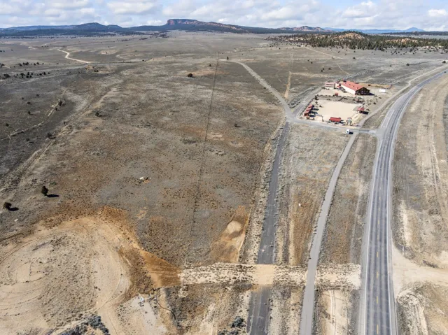 Aerial overview of property's location with a mountain backdrop and rural landscape