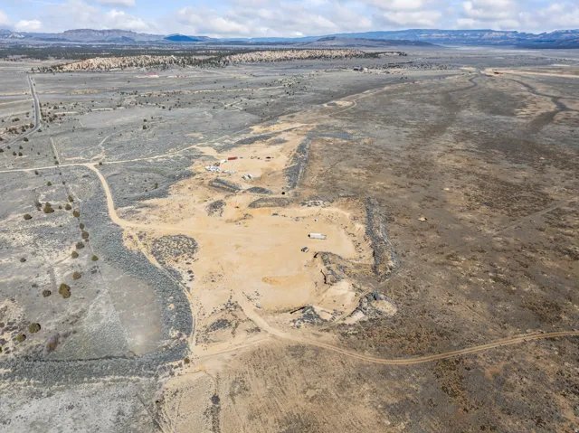 Aerial view of sparsely populated area featuring a desert landscape and a mountain backdrop