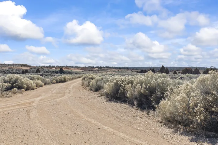 View of dirt / gravel road with a view of countryside