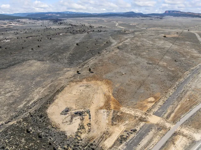 Aerial view of sparsely populated area with a desert landscape and a mountain backdrop