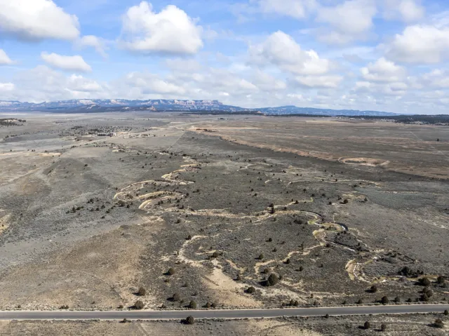 View of rural area with a desert landscape and a mountain backdrop