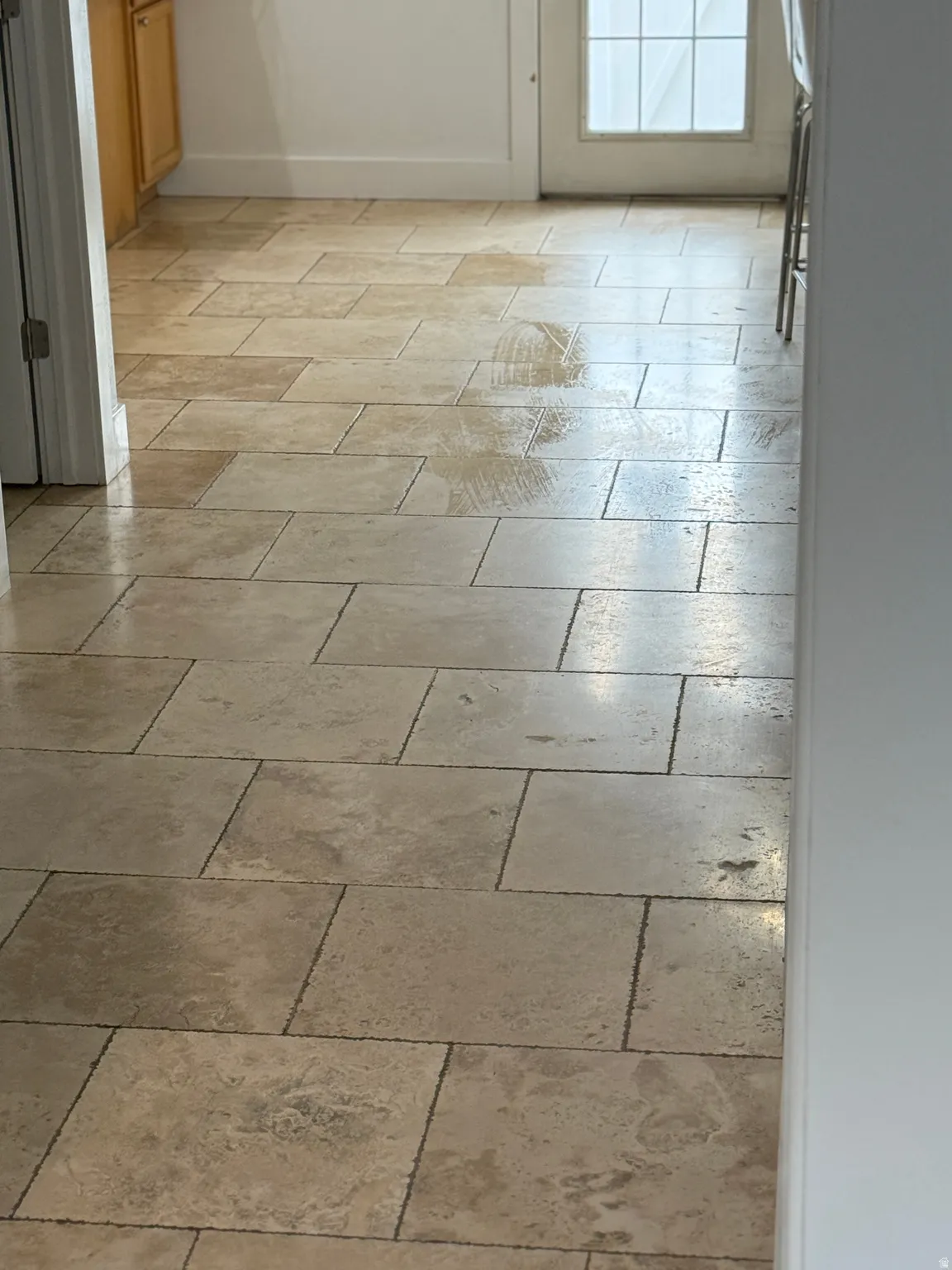 Detailed view of luxurious travertine floors throughout