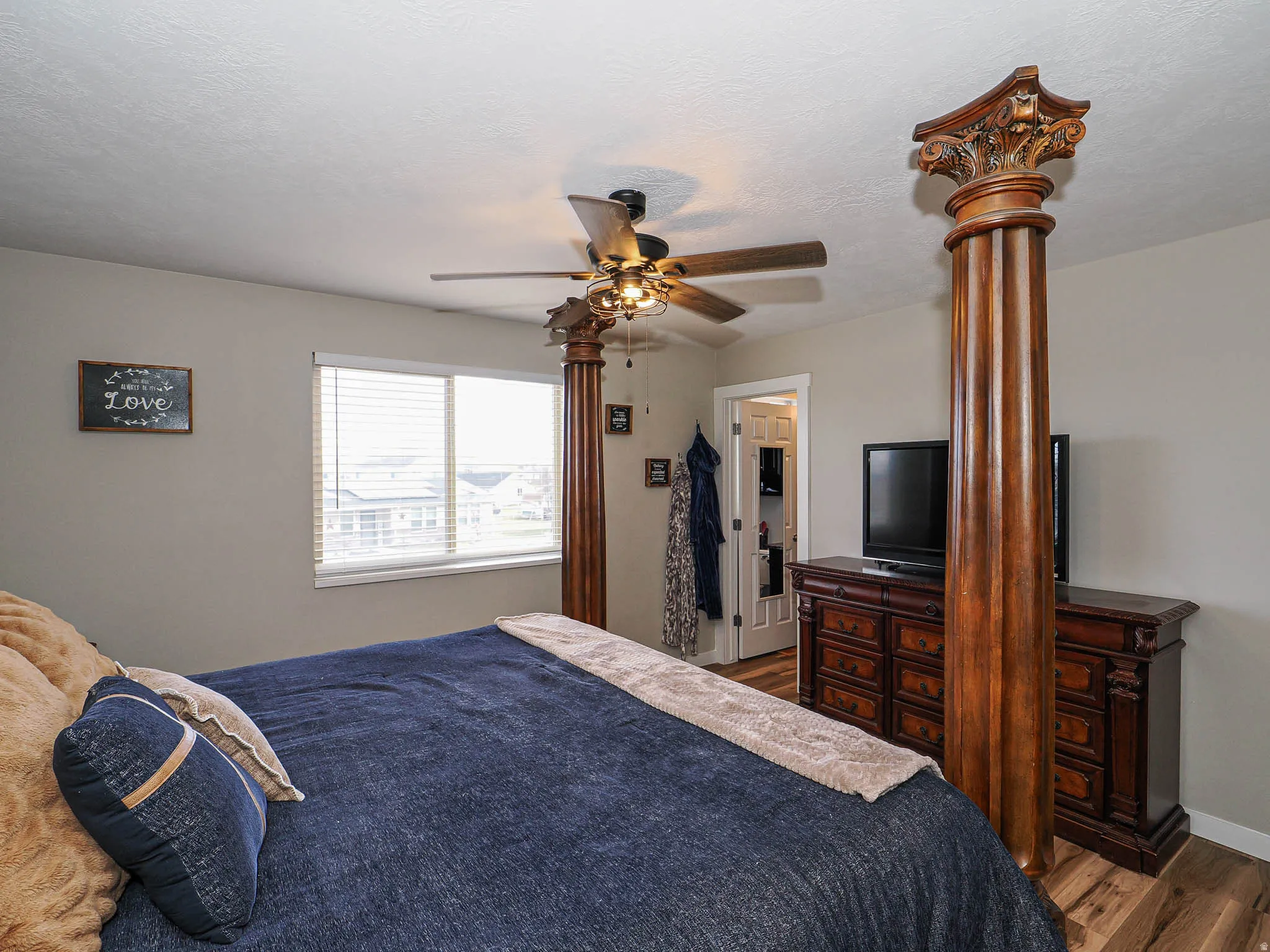 Bedroom with dark wood-style flooring and ceiling fan