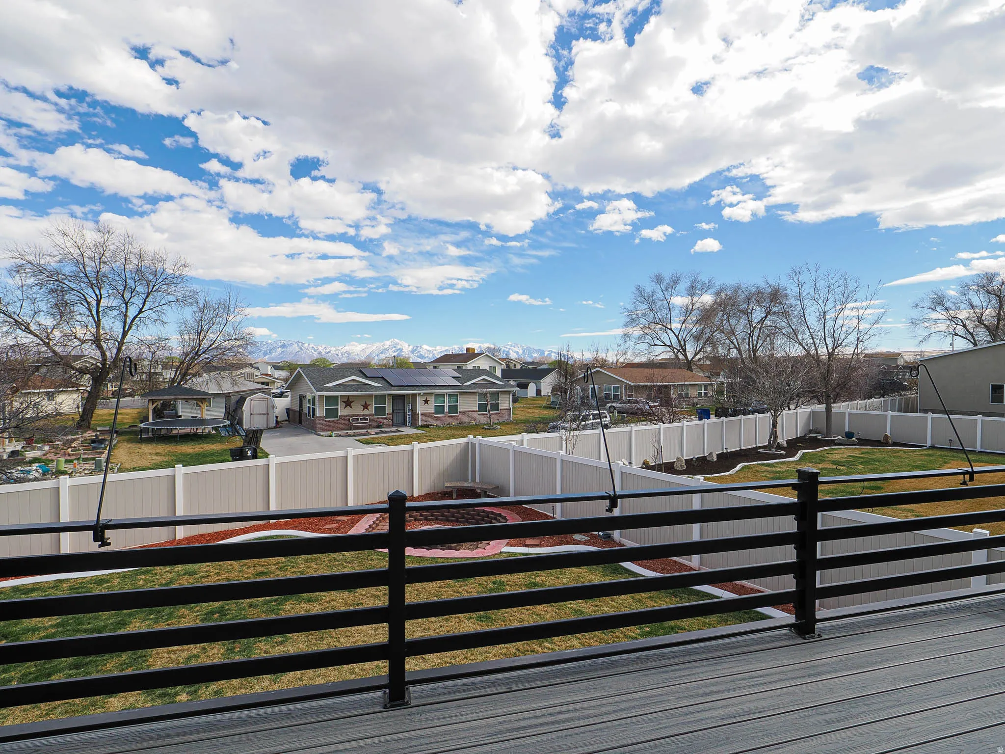 Deck featuring a residential view and a fenced backyard