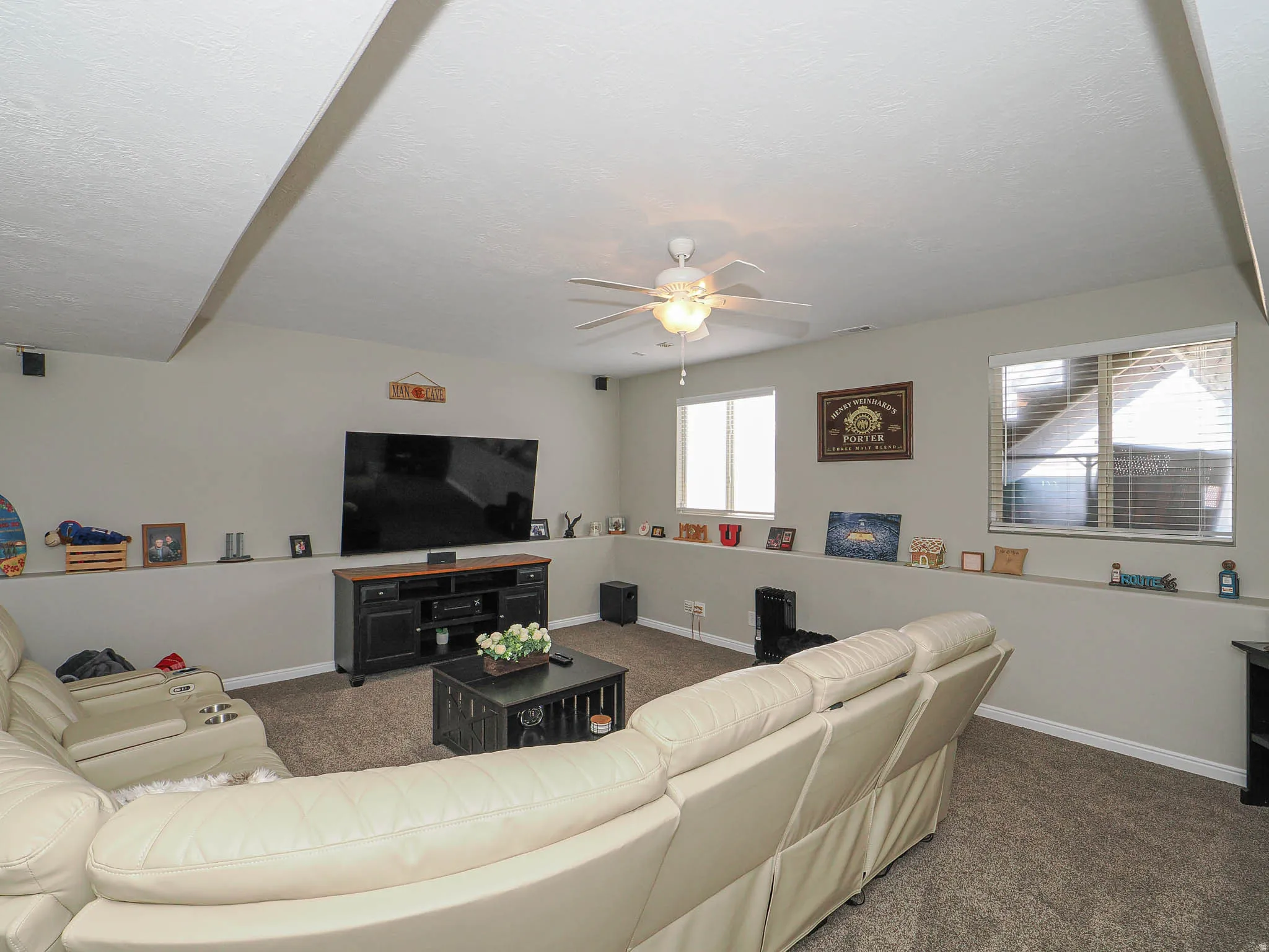 Living room with carpet floors and ceiling fan