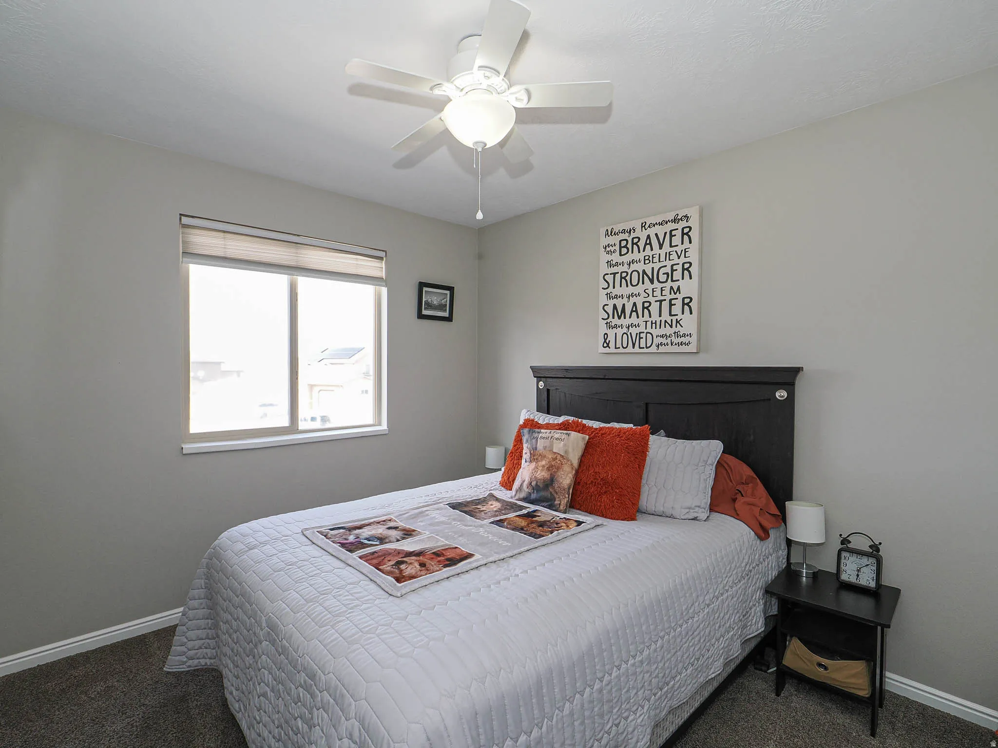 Bedroom featuring dark colored carpet and ceiling fan