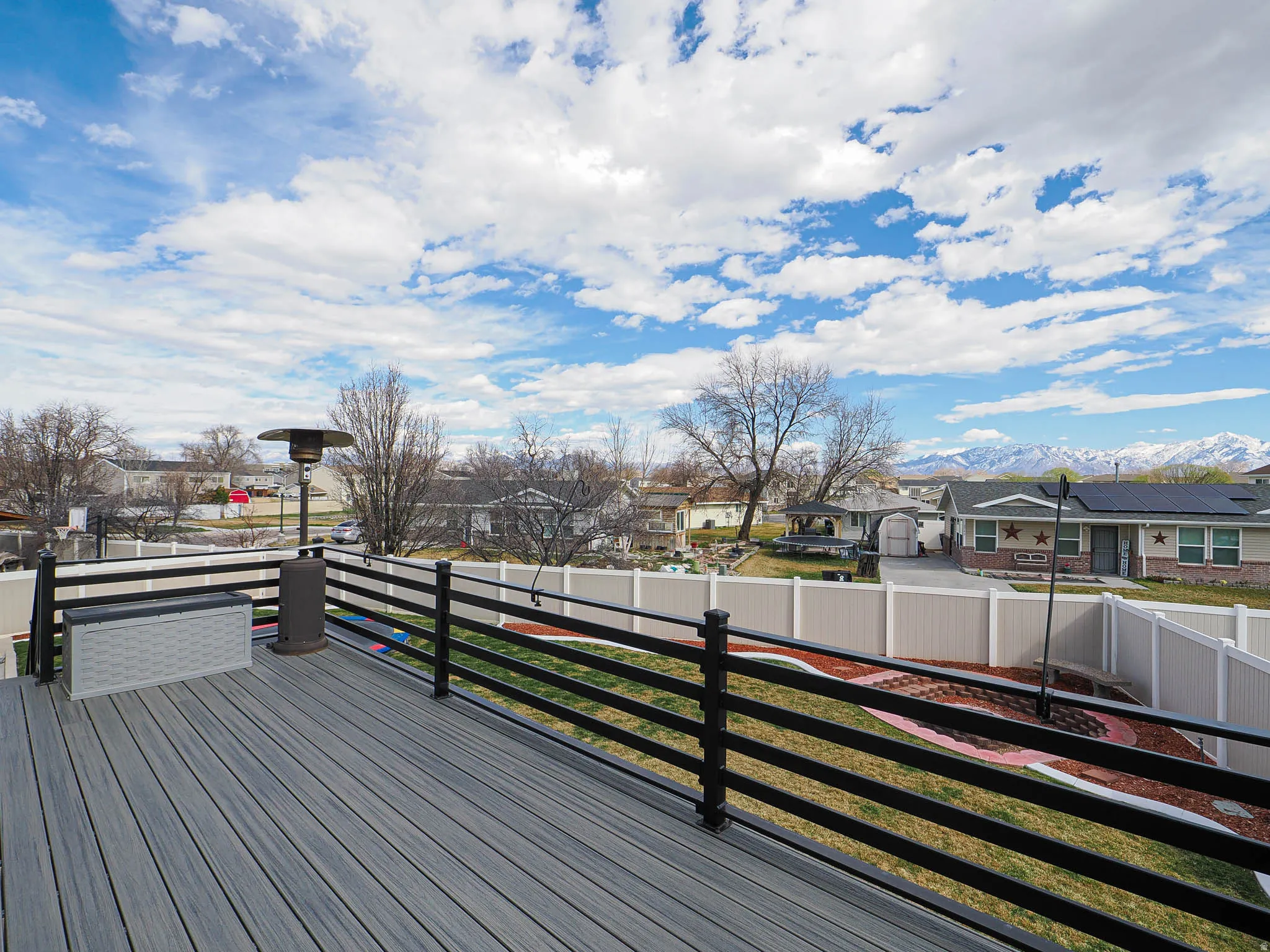 Wooden terrace featuring a residential view