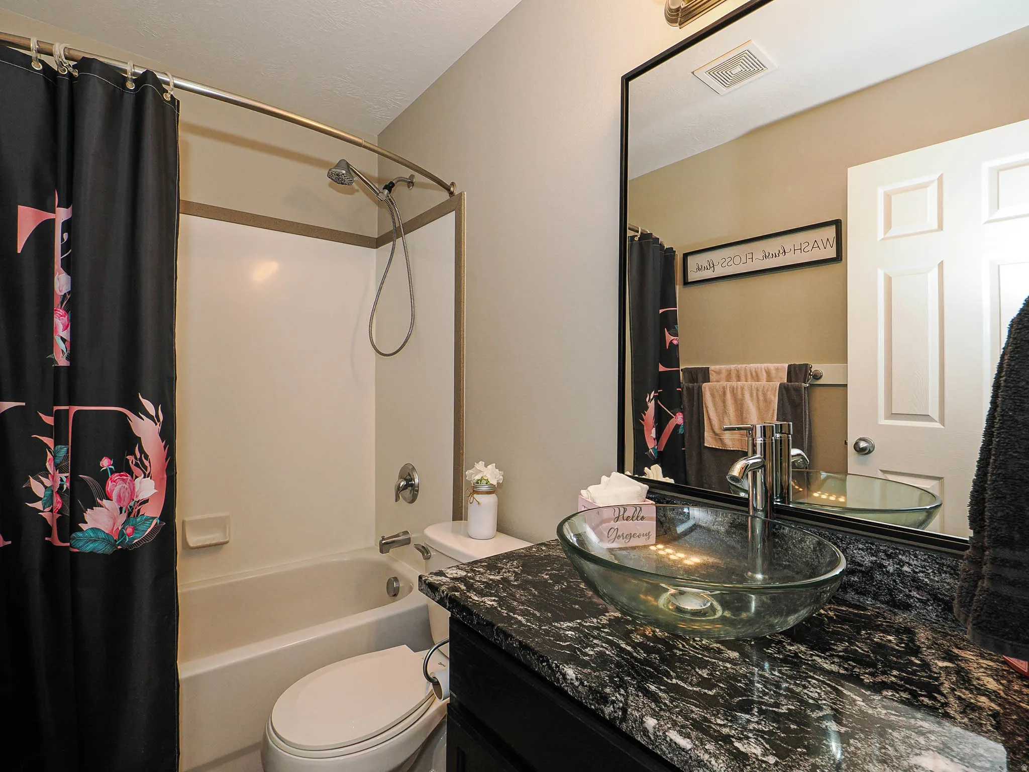 Full bath featuring vanity and shower / bath combo with shower curtain