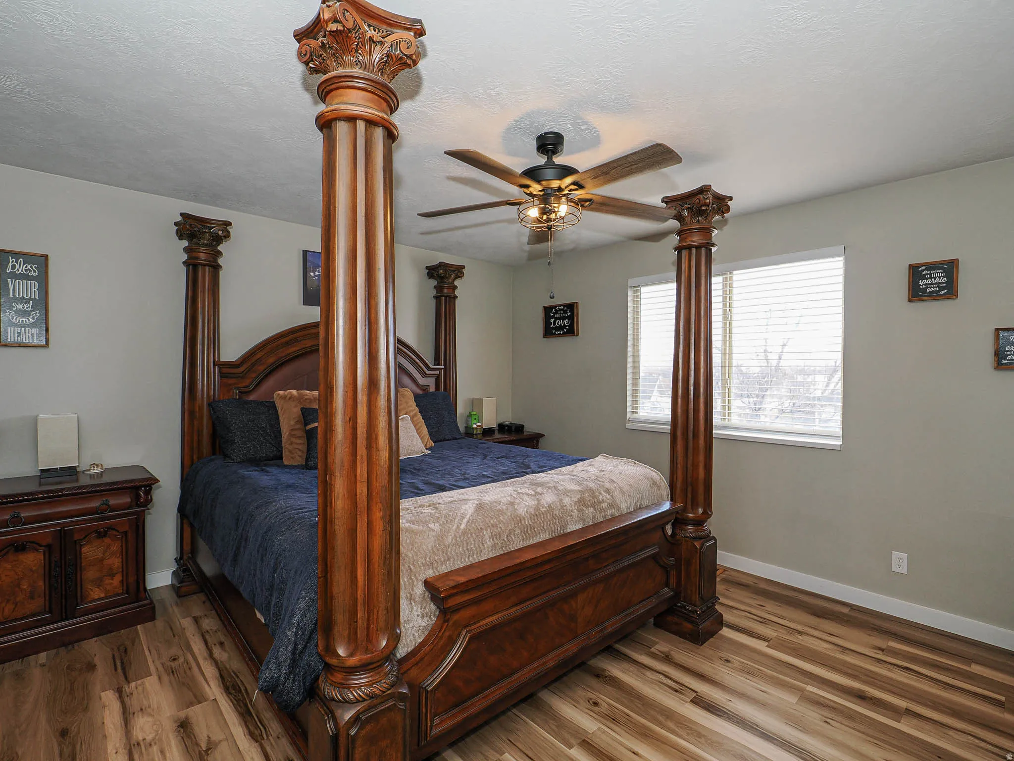 Bedroom featuring wood finished floors and a ceiling fan
