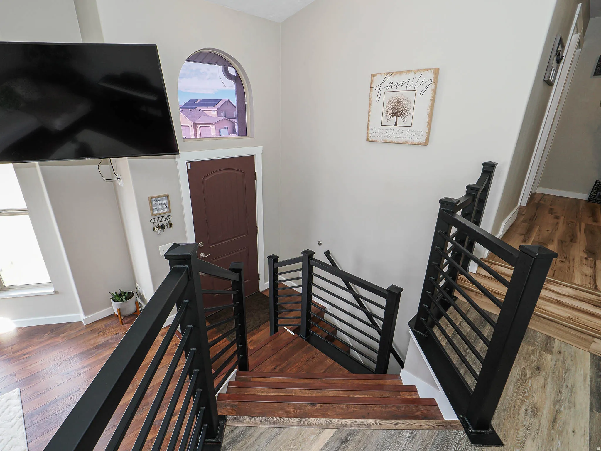 Foyer with wood finished floors and baseboards