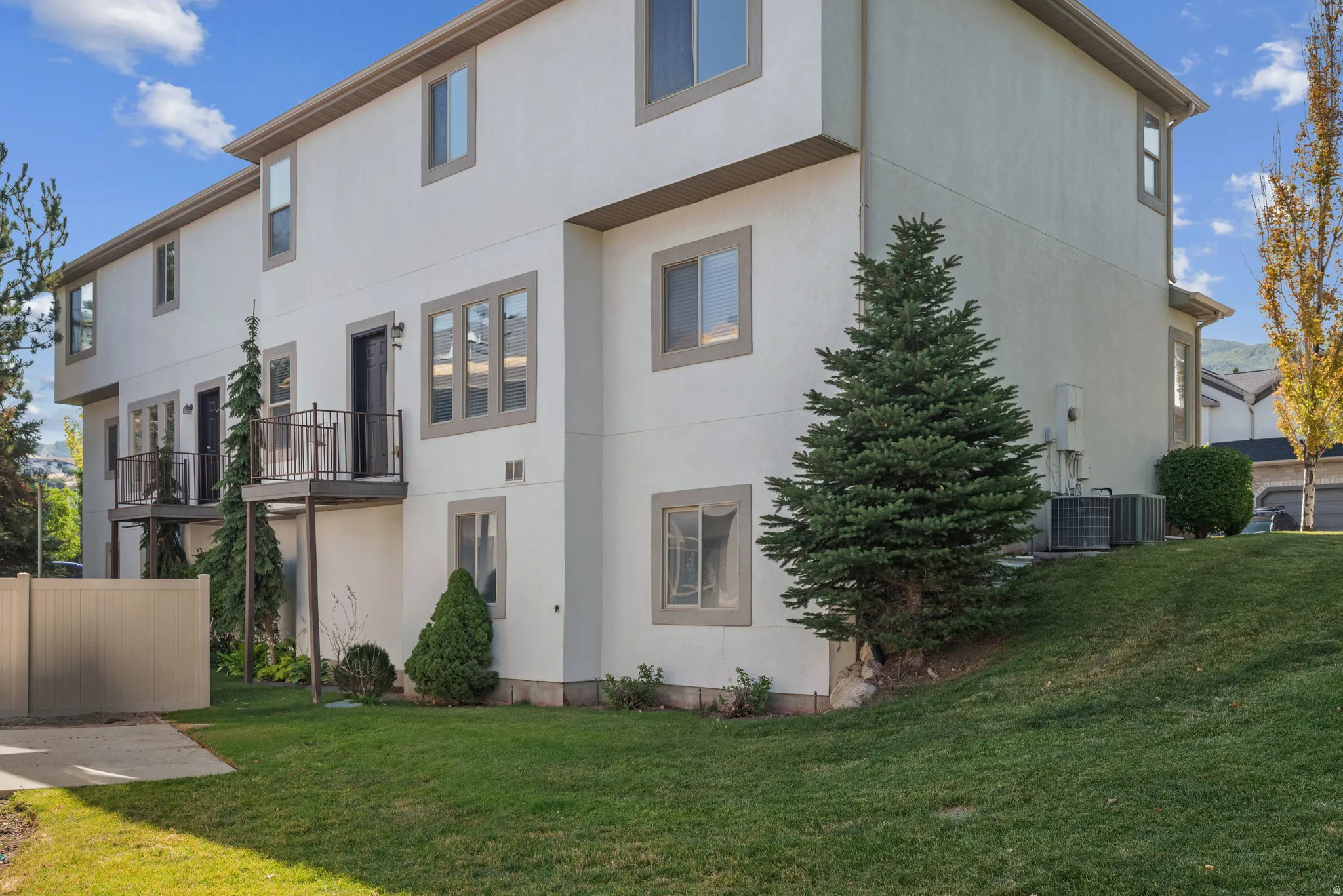 Rear view of property with a balcony and stucco siding