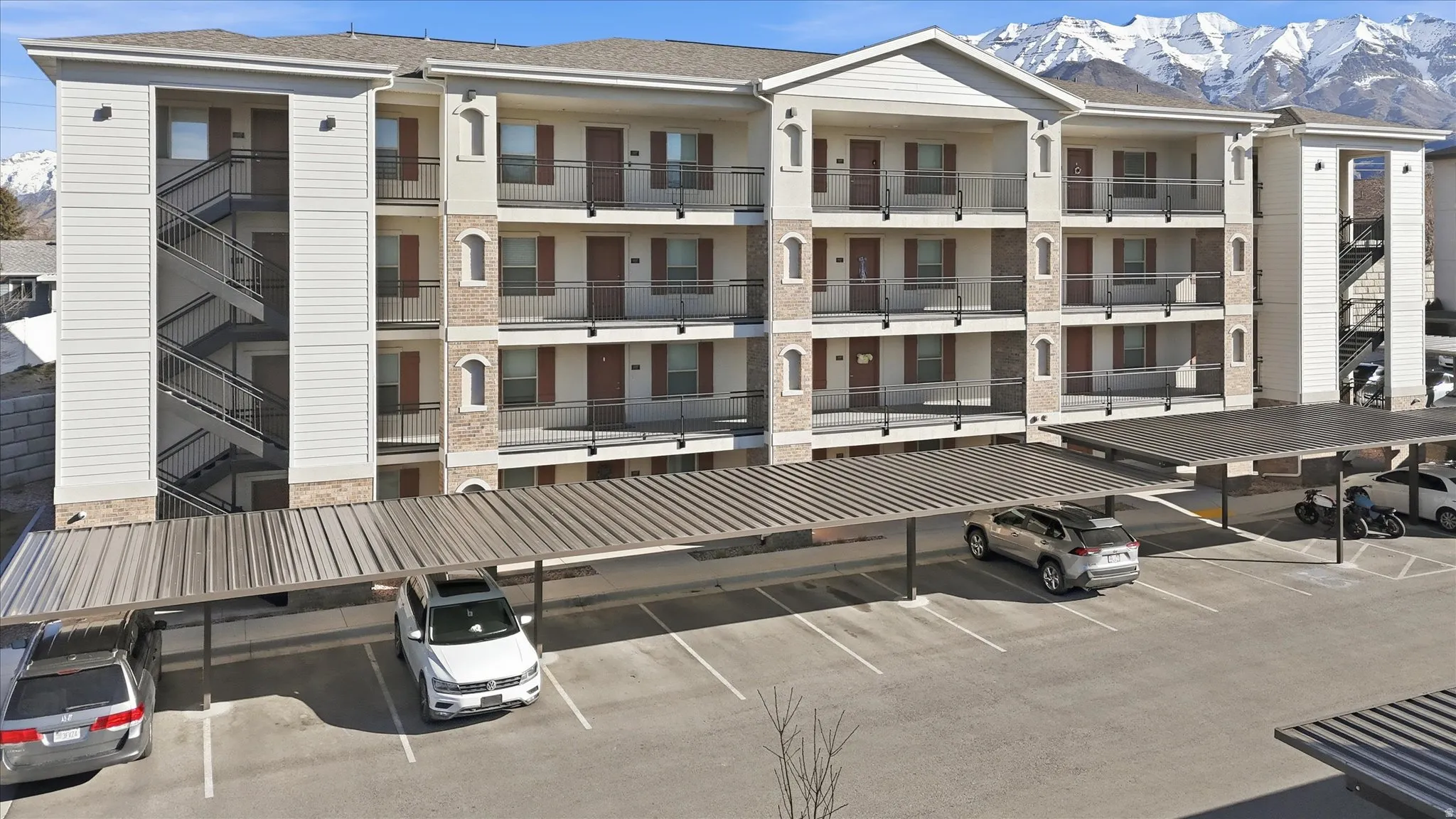 View of building exterior featuring covered parking