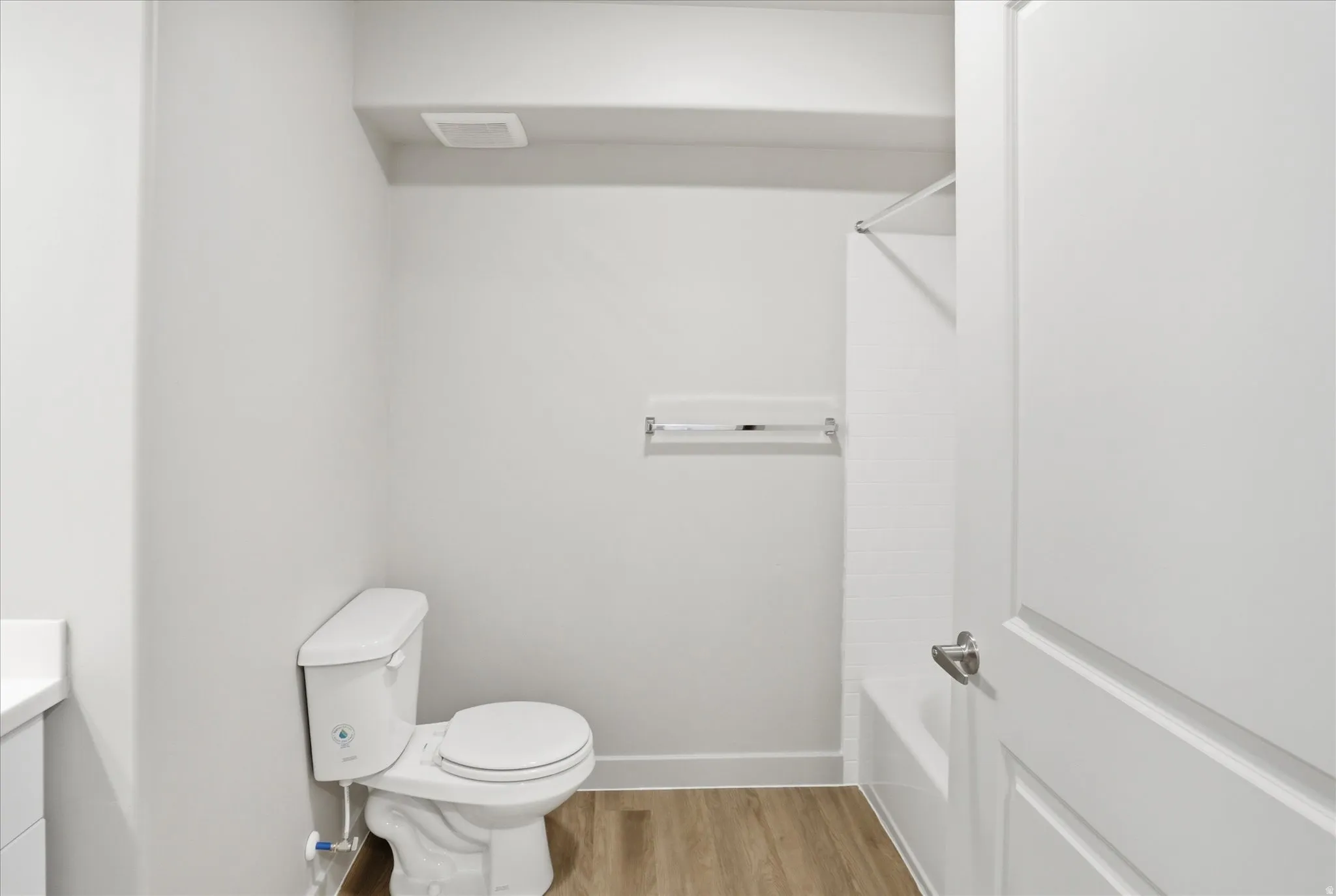 Bathroom featuring vanity, light wood-style flooring, and shower / bathtub combination