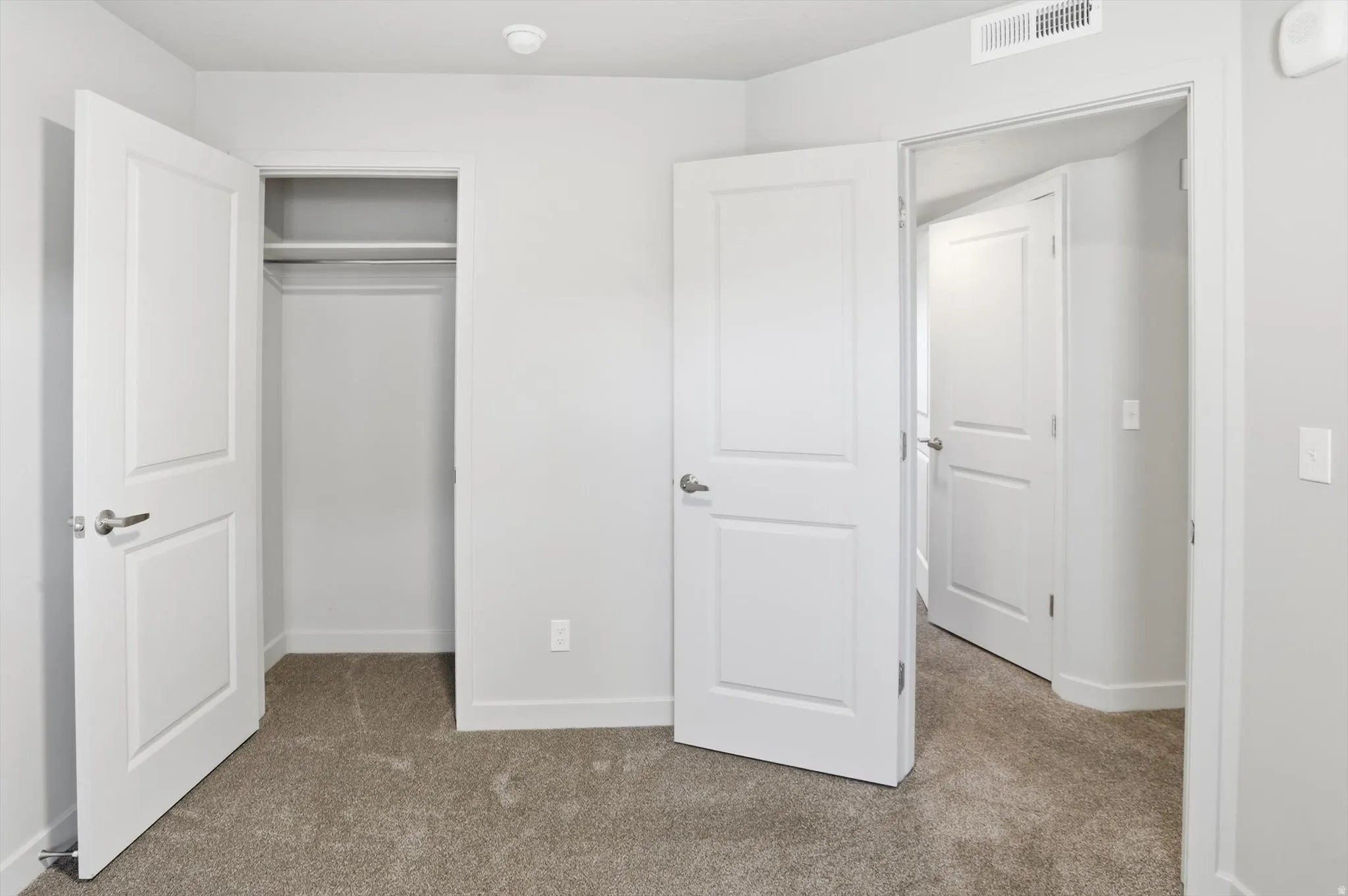 Unfurnished bedroom with carpet floors and a closet