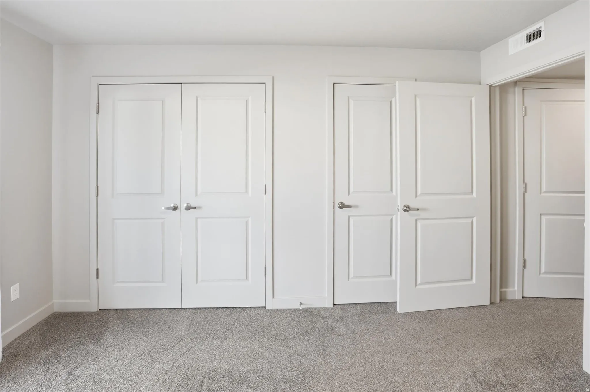 Unfurnished bedroom featuring carpet flooring and a closet