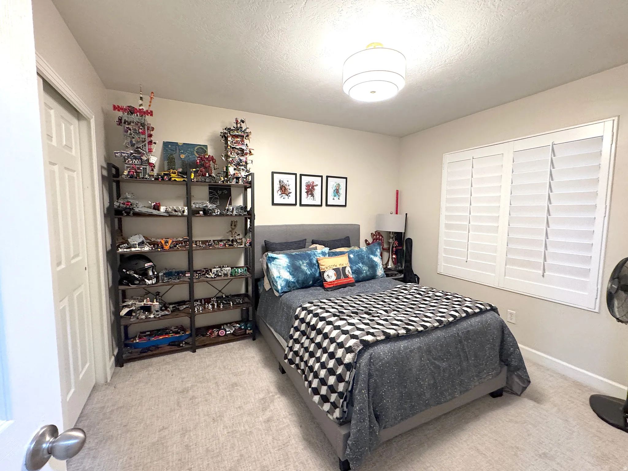 Bedroom with light carpet and plantation shutters