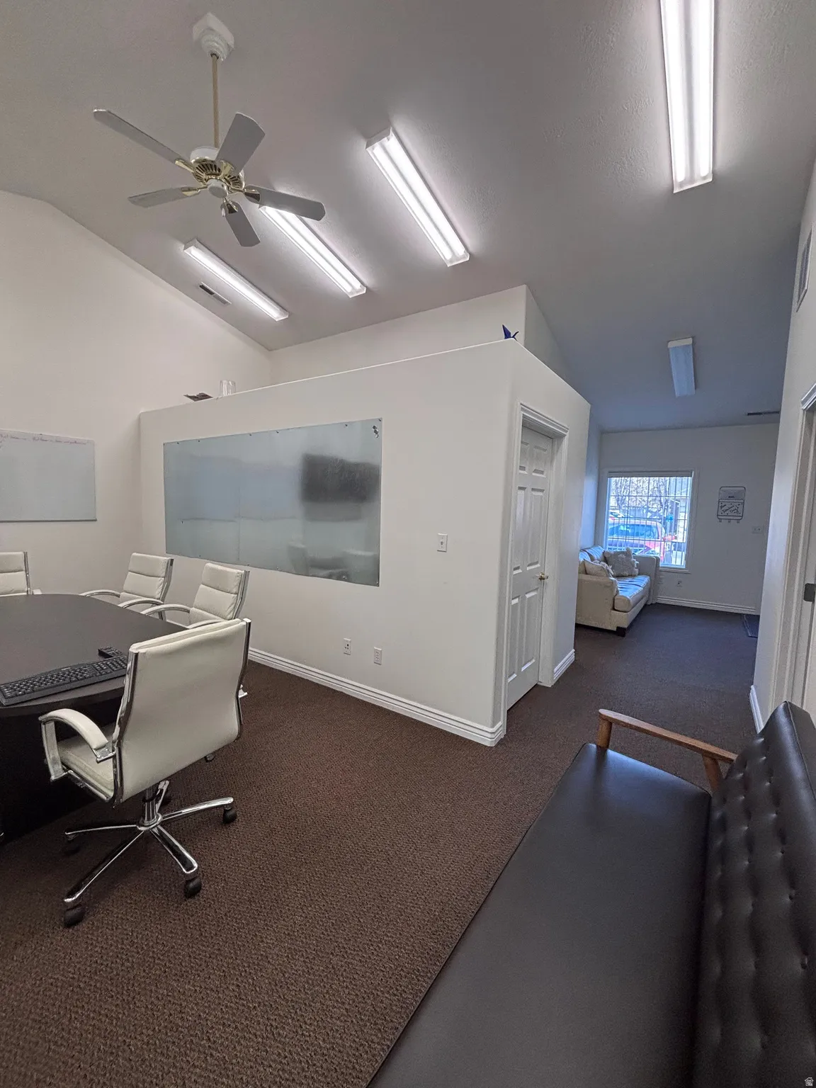Office space with vaulted ceiling and a ceiling fan