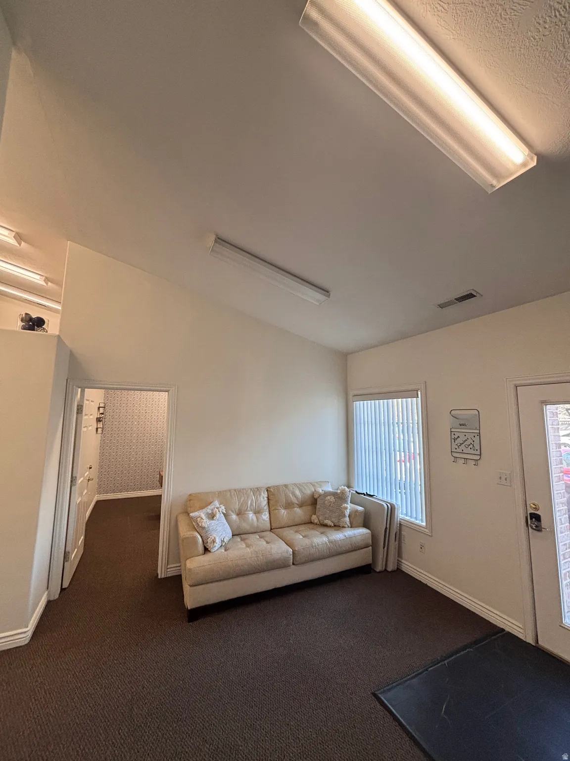 Living room featuring dark colored carpet