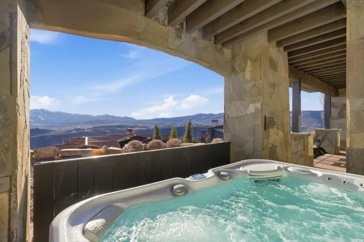 View of swimming pool featuring a hot tub and a mountain view