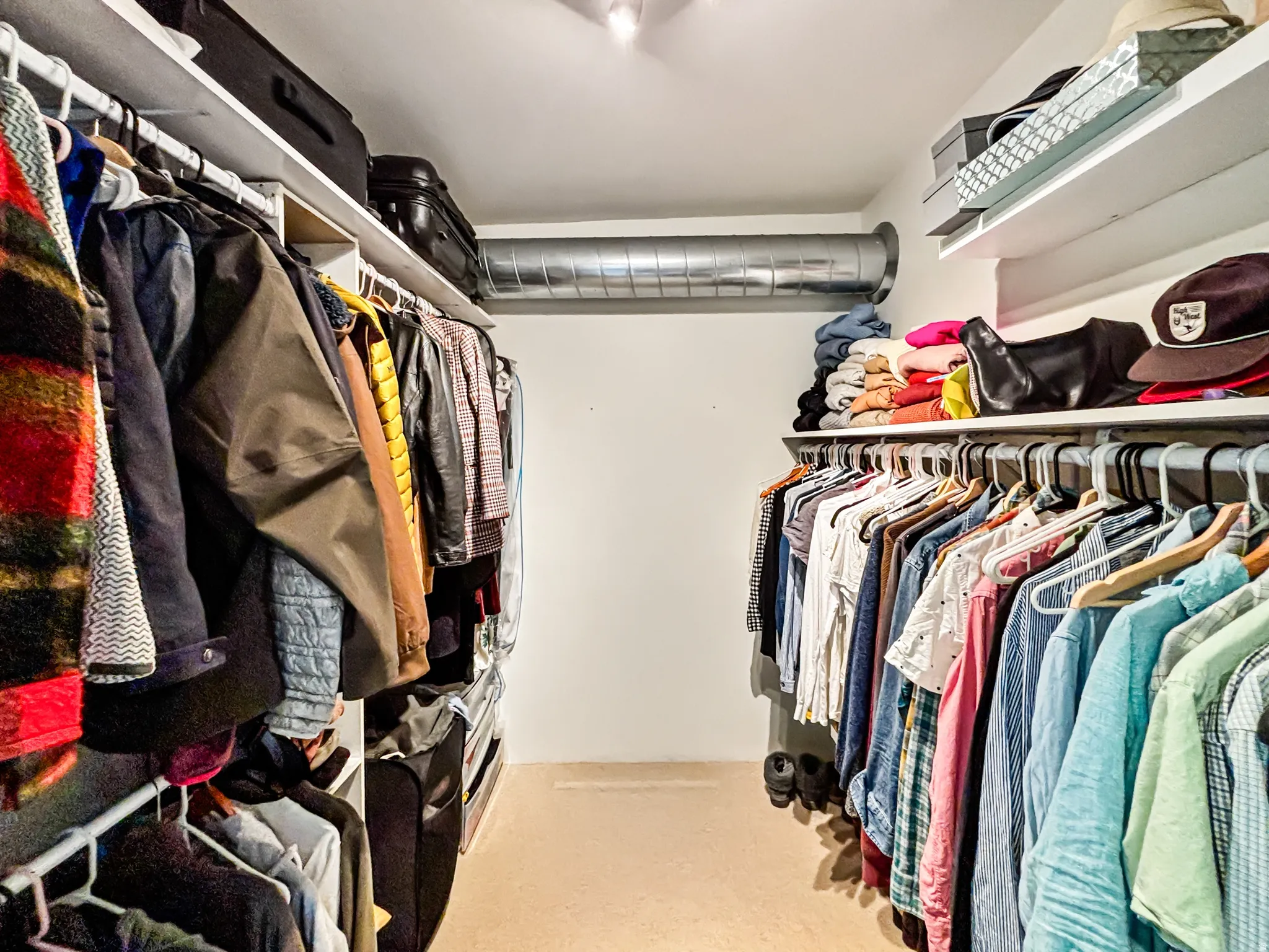 Walk in closet with light carpet