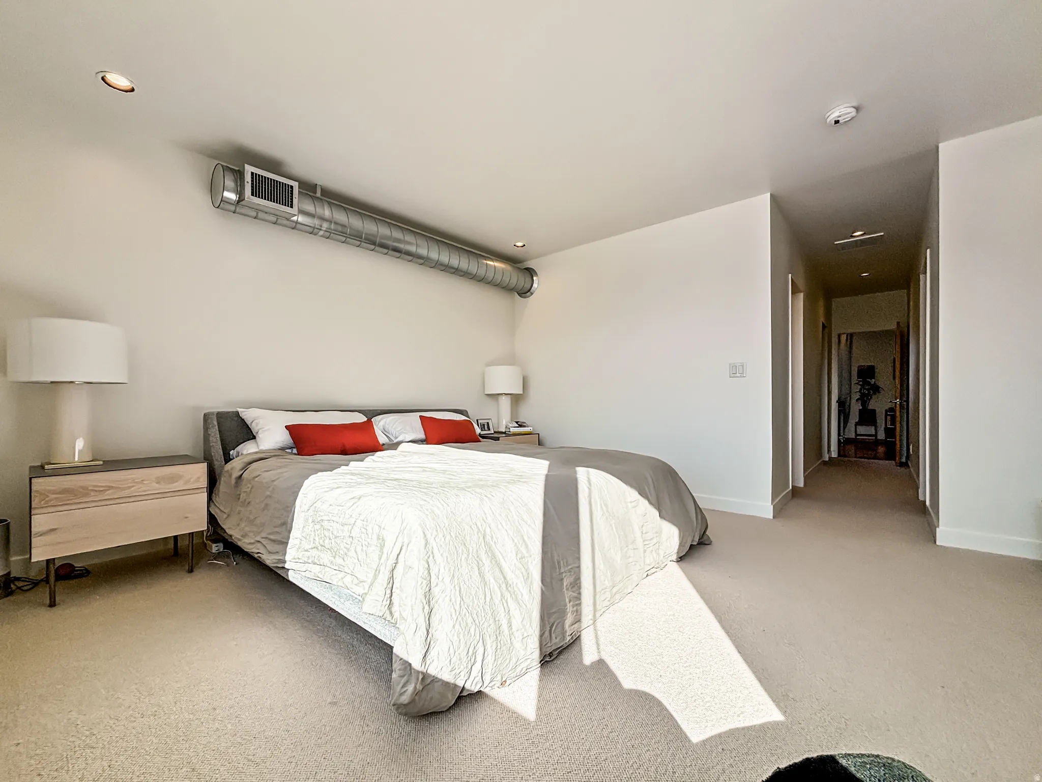 Bedroom featuring light carpet and baseboards