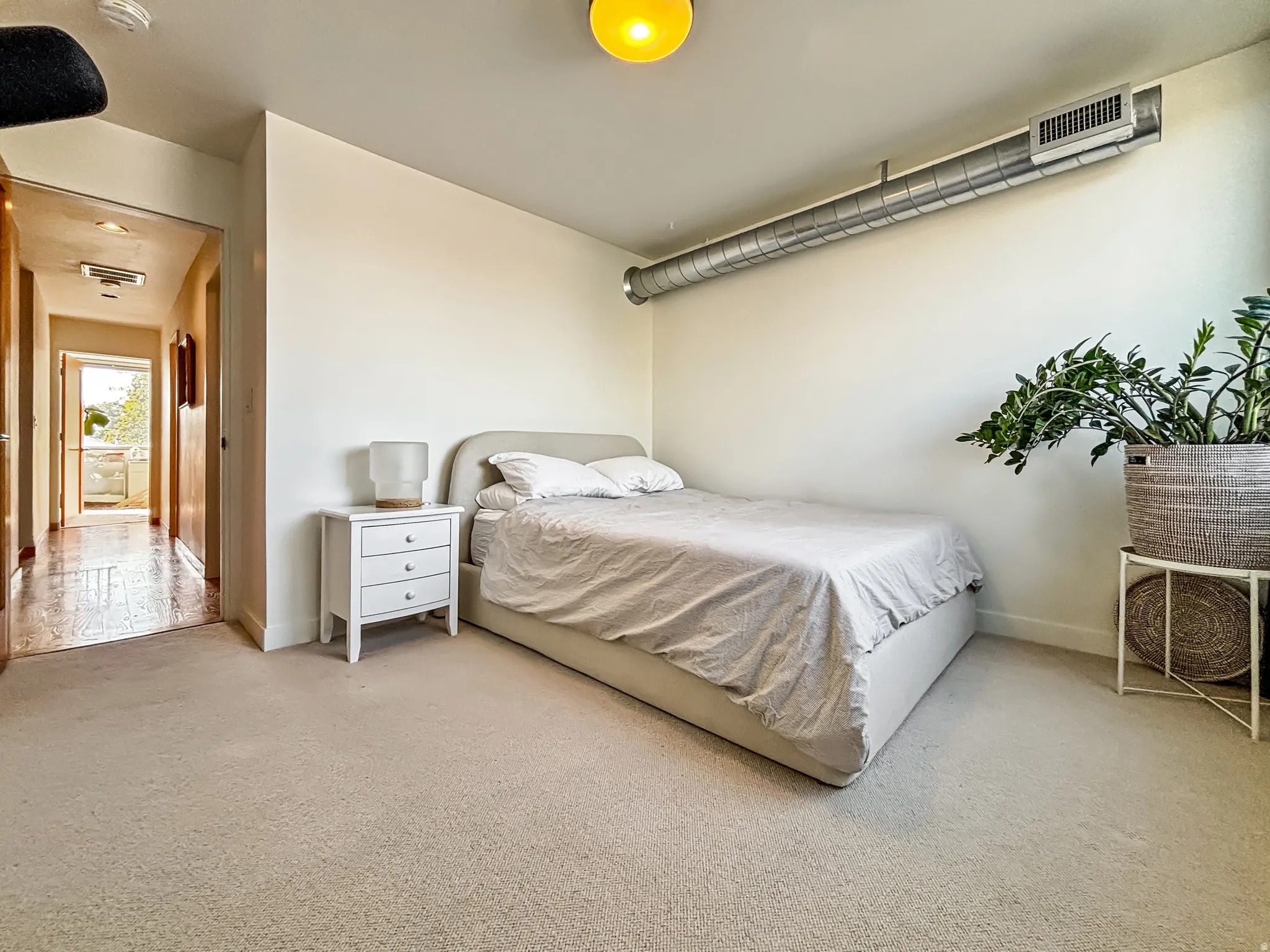 Bedroom with light carpet and baseboards