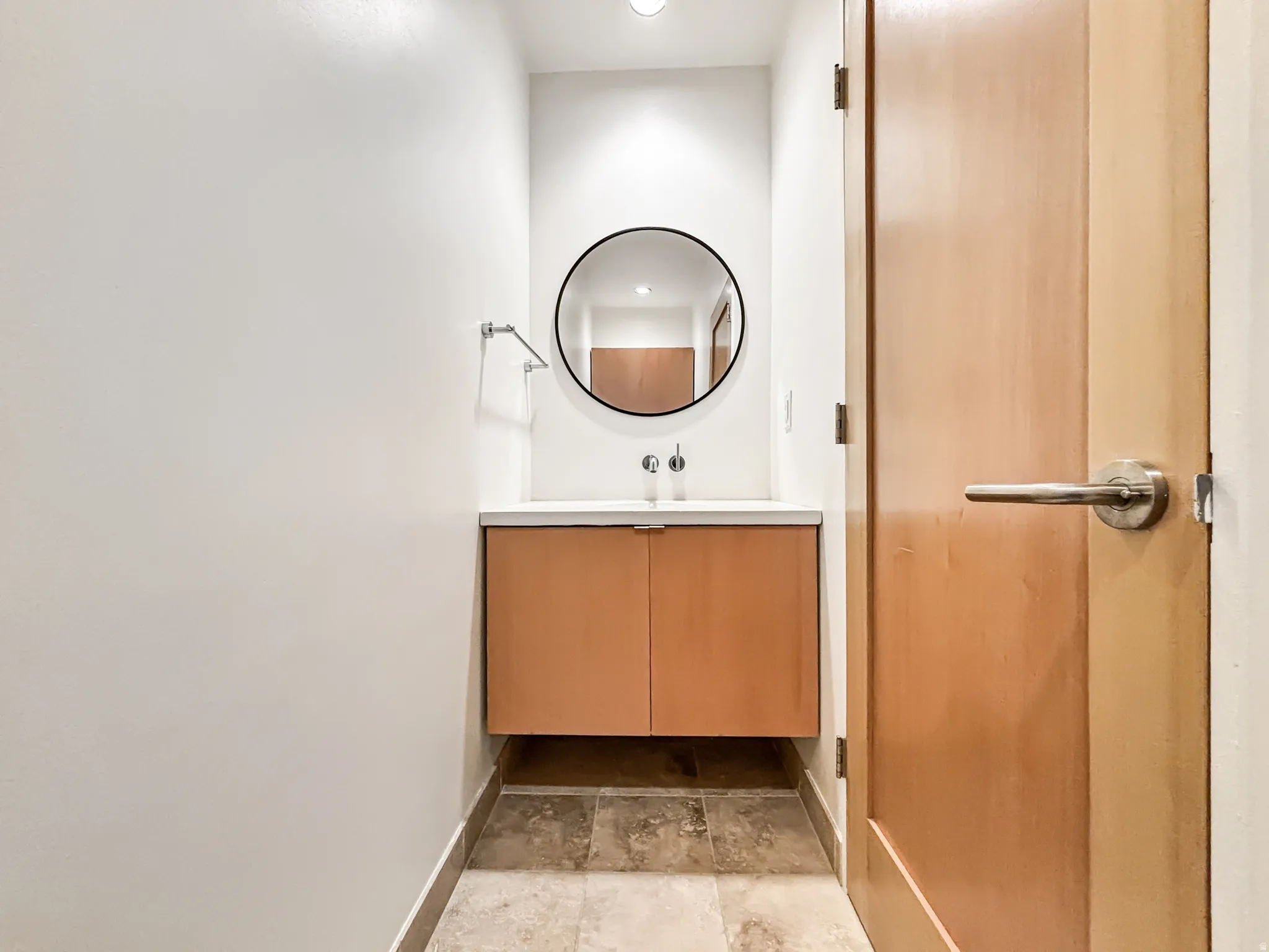 Bathroom with vanity and light stone finish flooring
