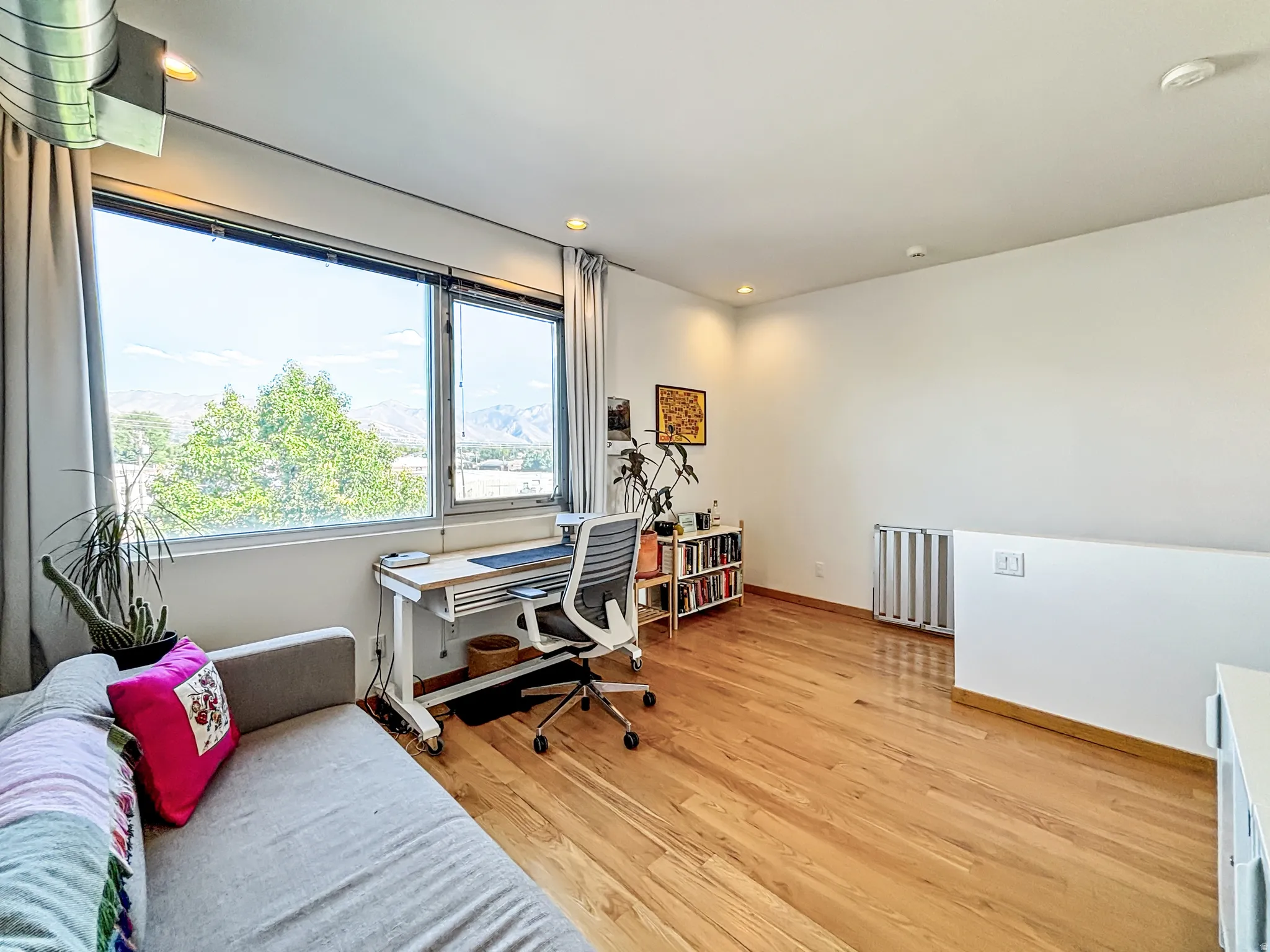 Office area featuring light wood finished floors, recessed lighting, and a mountain view