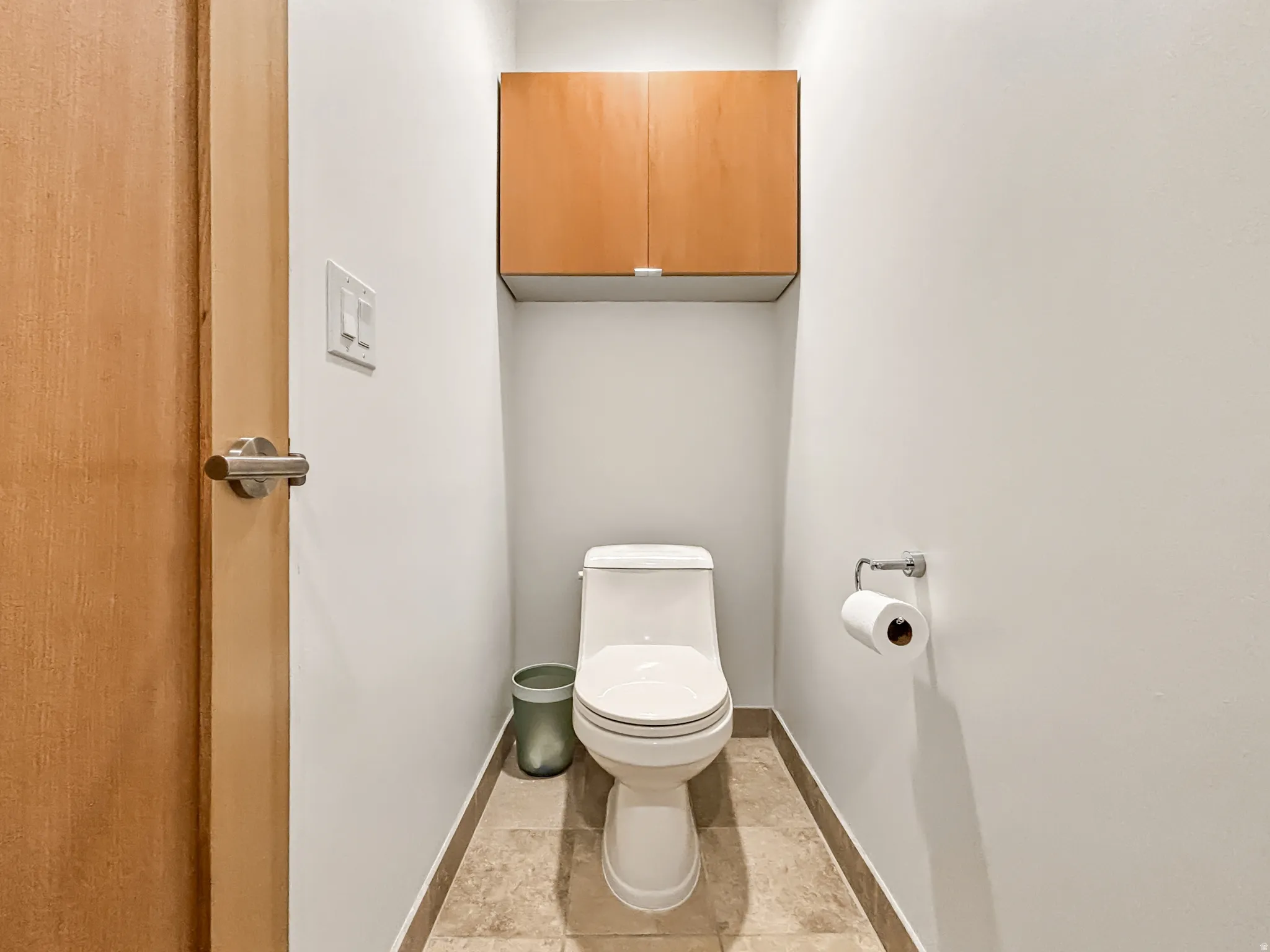 Bathroom with toilet and baseboards