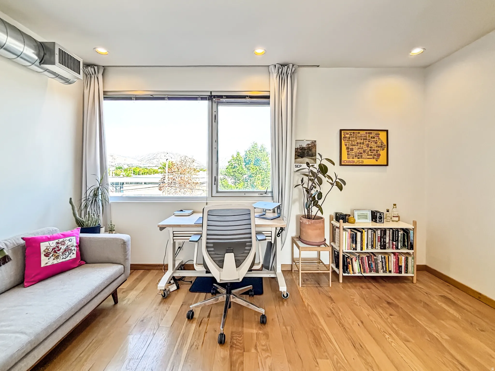 Home office with light wood finished floors, recessed lighting, and a mountain view