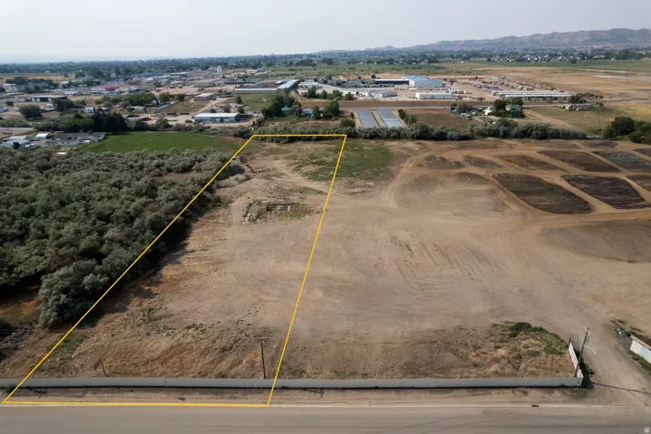 Aerial view of sparsely populated area with property parcel outlined