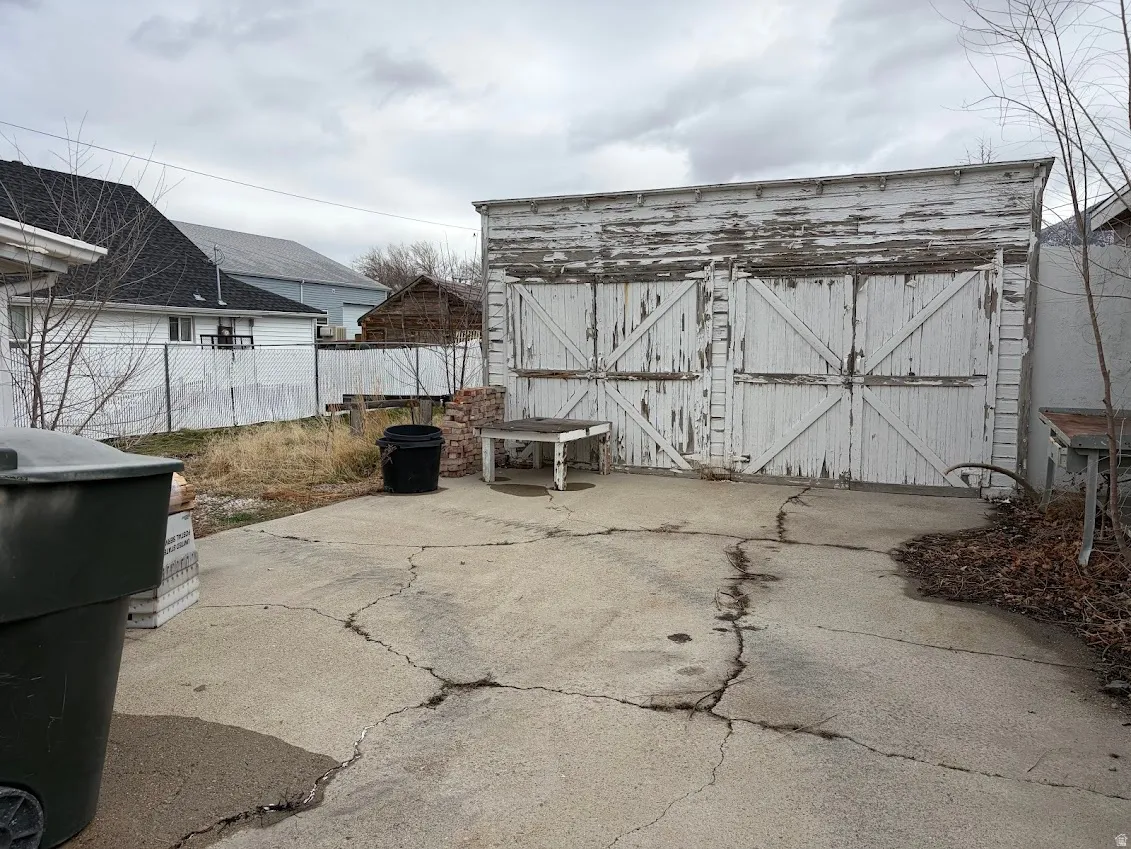 View of patio with a shed