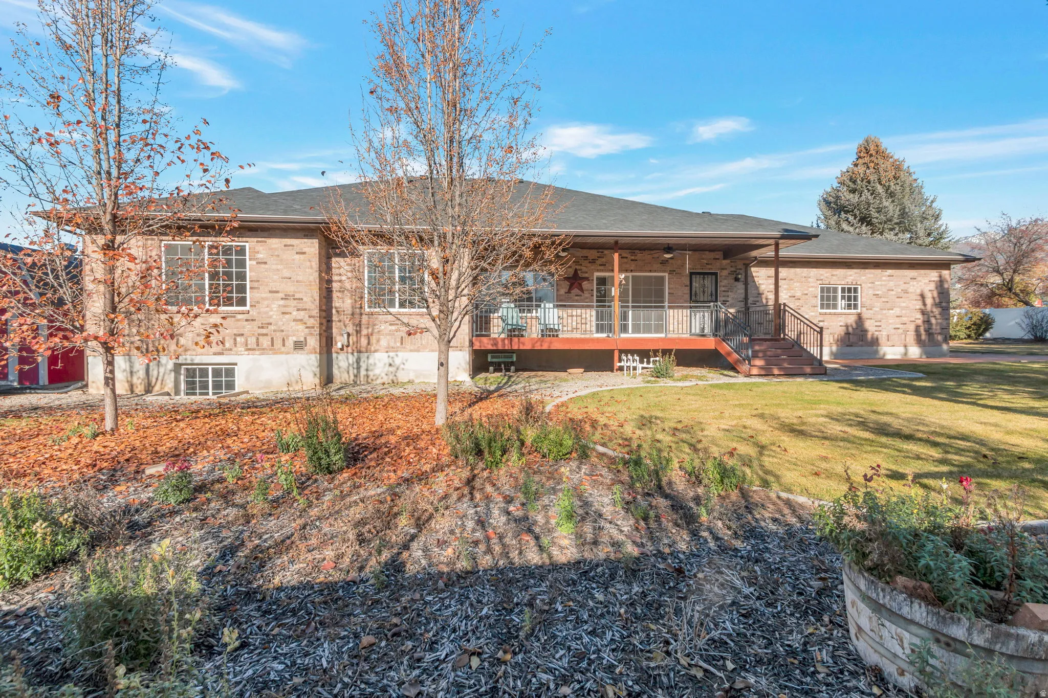View of front facade featuring brick siding, covered porch, and a front lawn