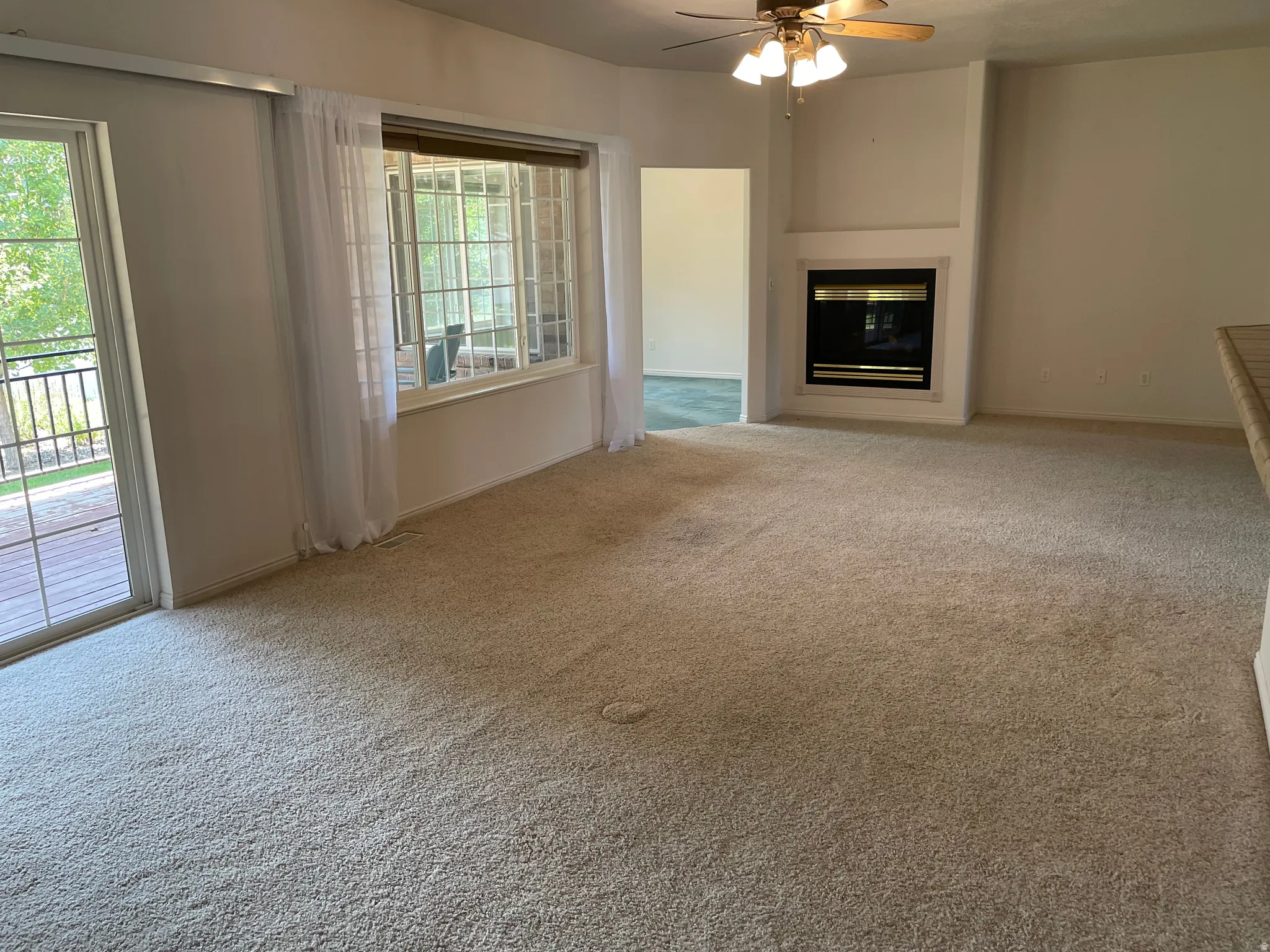 Carpeted living space with a built-in fireplace featuring a black firebox