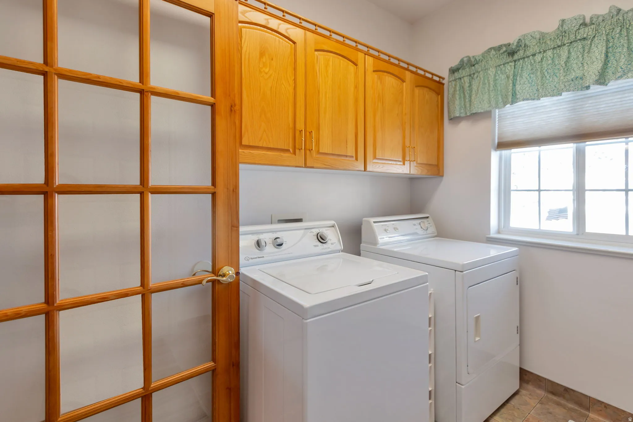 Laundry room with cabinet space and independent washer and dryer
