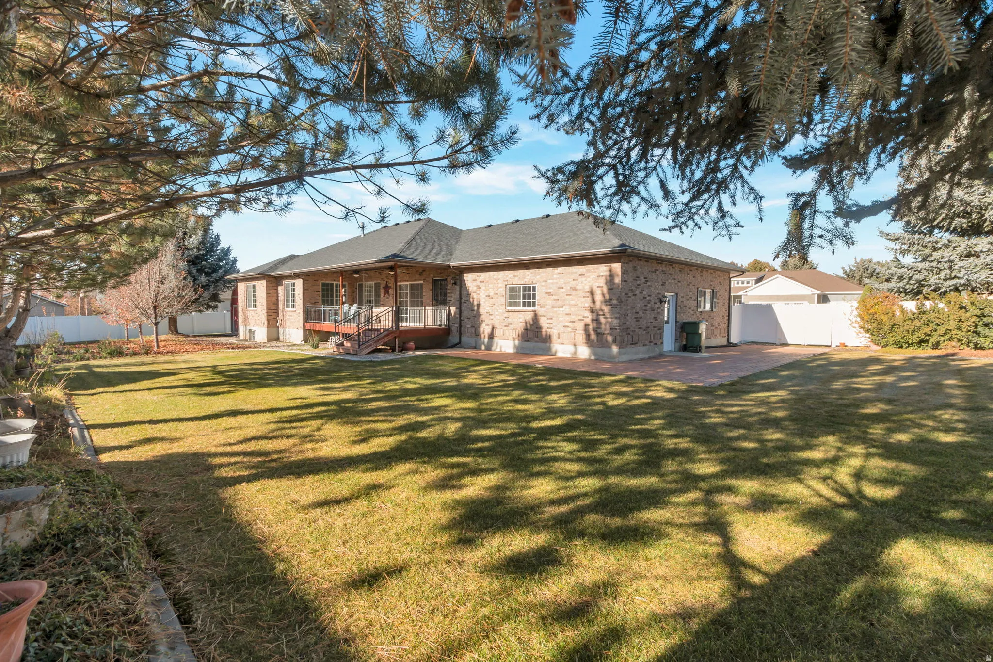 Back of property featuring brick siding and a shingled roof