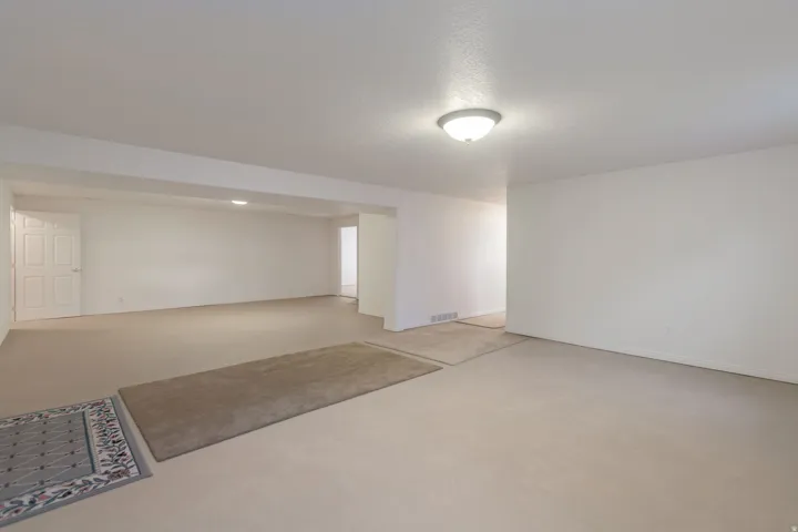 Unfurnished room featuring concrete flooring and baseboards