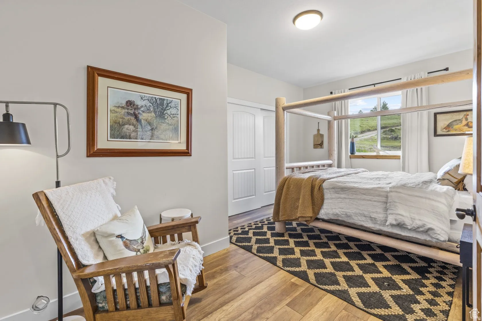 Bedroom featuring a closet and light wood-style floors