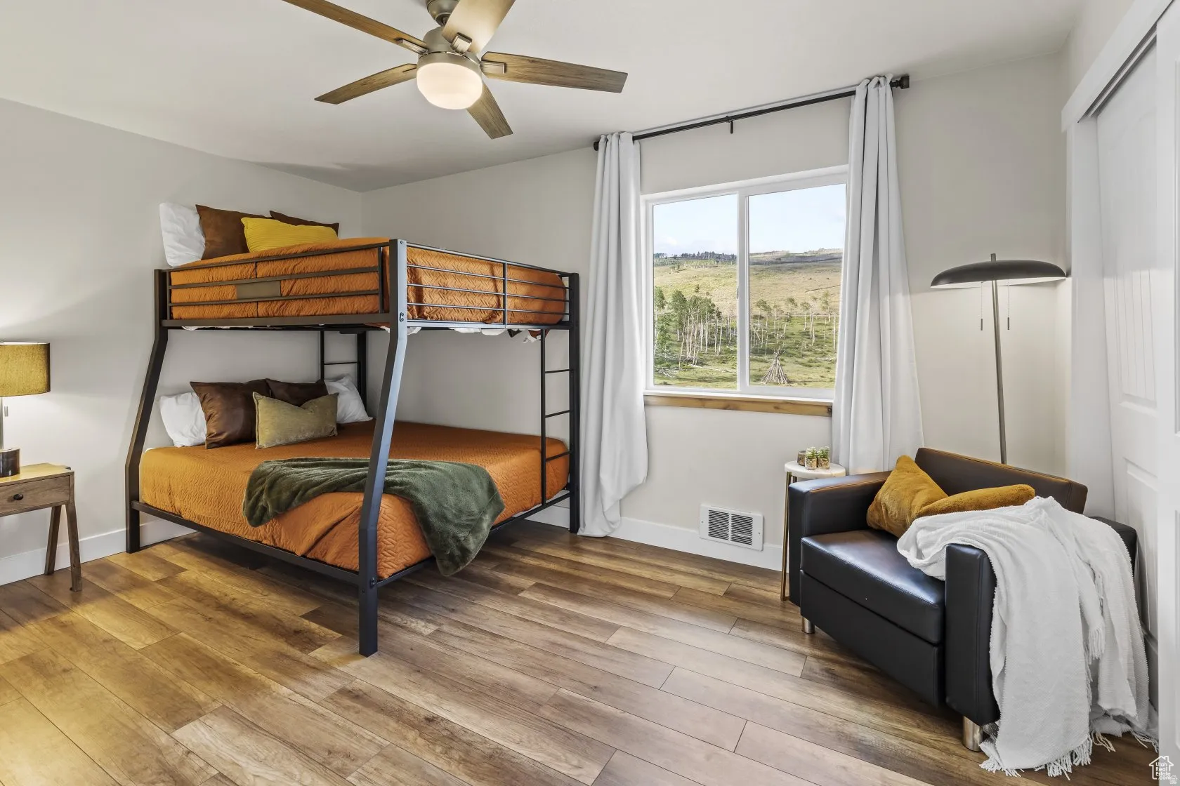 Bedroom featuring wood-type flooring and ceiling fan