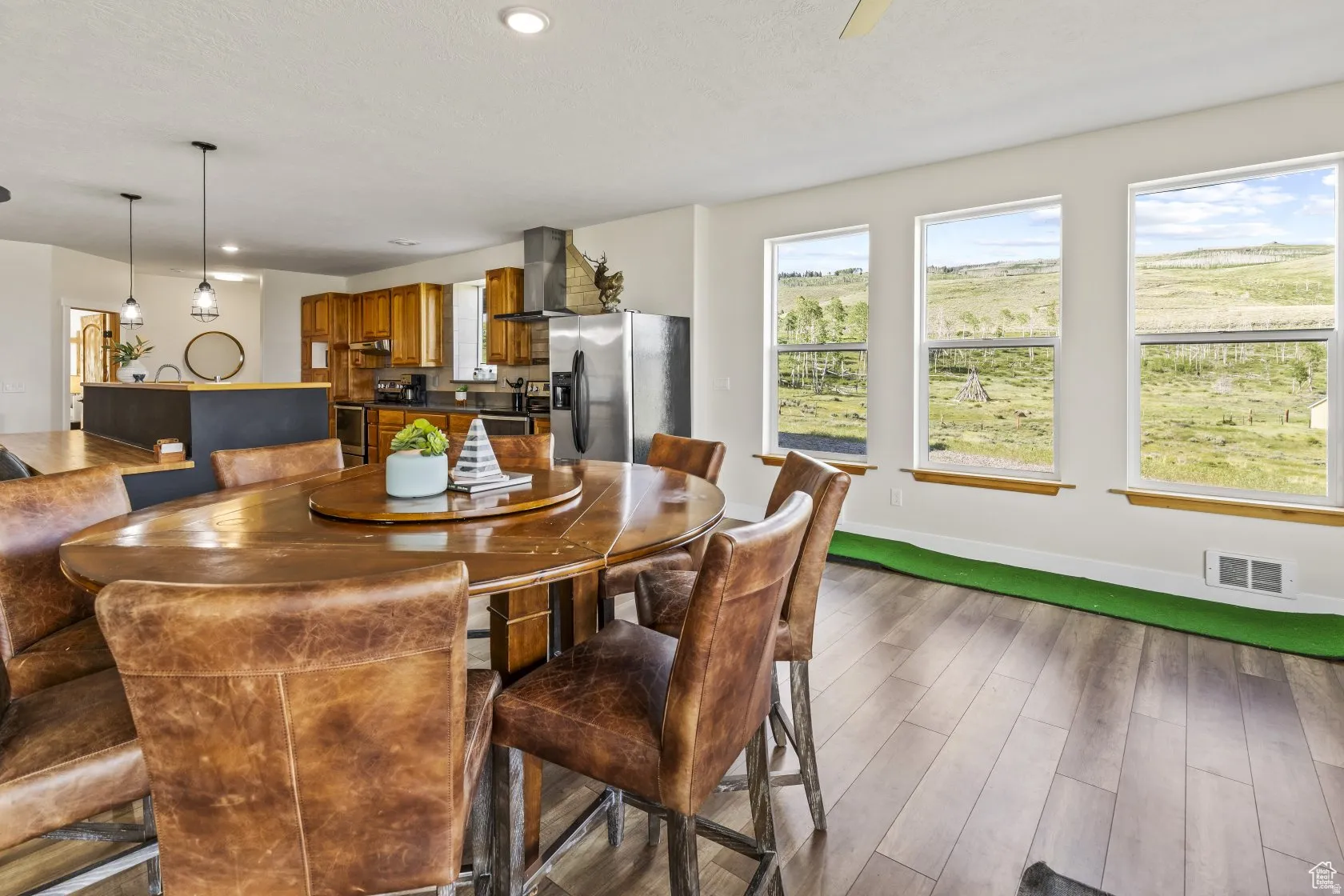 Dining space featuring dark wood-style flooring and recessed lighting