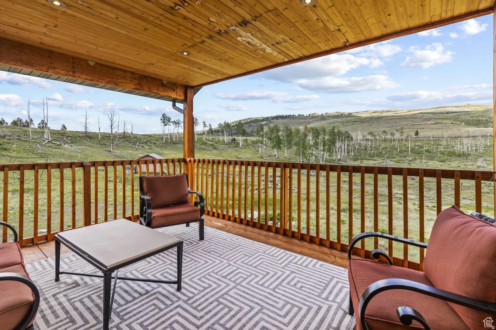 Wooden deck featuring a yard and a view of rural / pastoral area