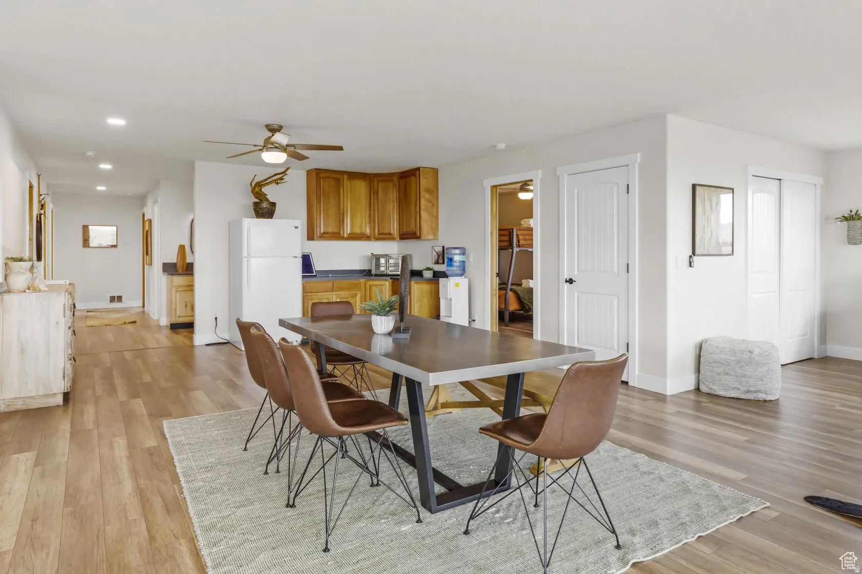 Dining area featuring a ceiling fan, light wood-type flooring, and recessed lighting