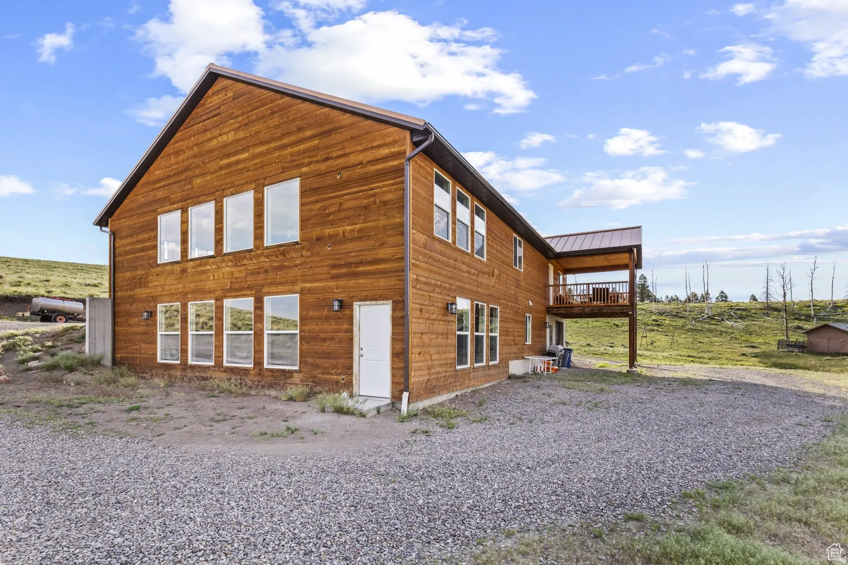 View of side of property with a metal roof