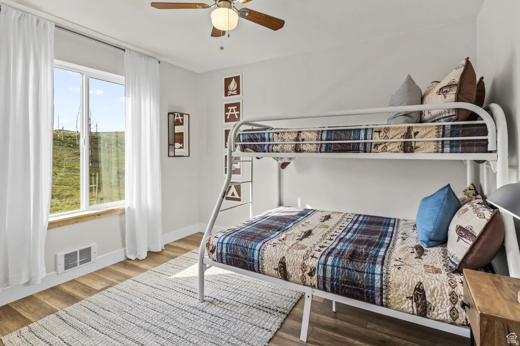 Bedroom featuring wood finished floors and a ceiling fan
