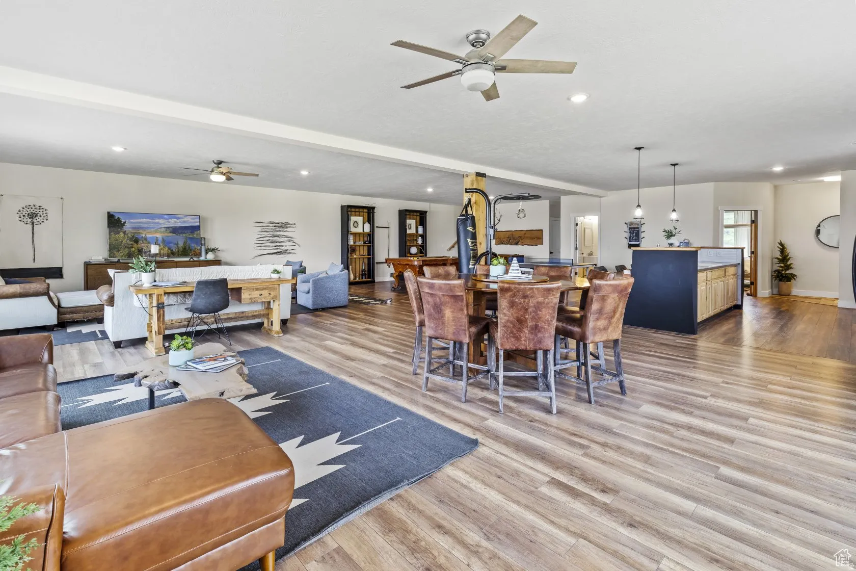 Dining area with light wood finished floors, ceiling fan, recessed lighting, and beamed ceiling