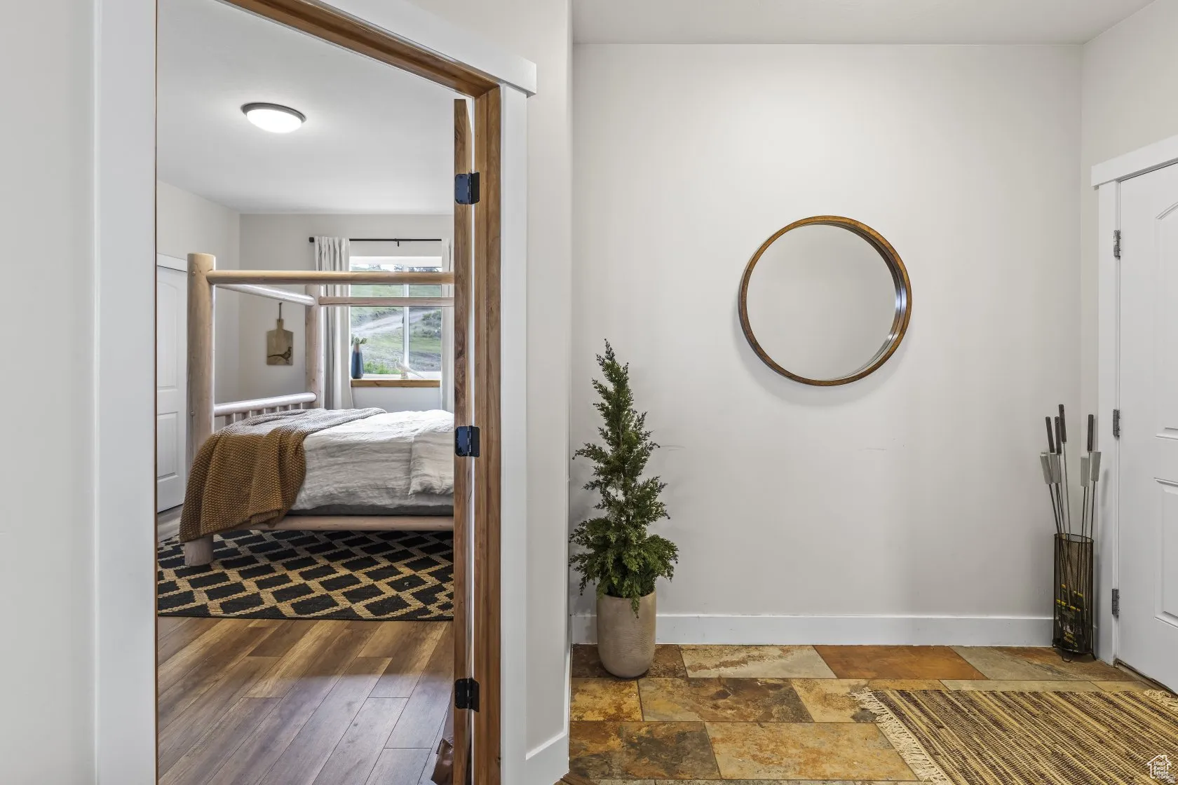 Entrance foyer featuring baseboards and stone finish flooring